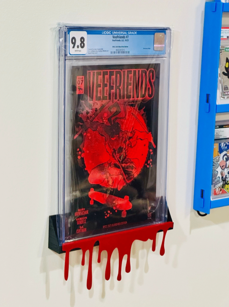 Graded comic on a black shelf.