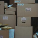 Vertical stack of cardboard boxes labeled 'fragile' for shipping and storage.